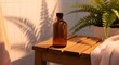 © Bali Perfect Sunrise - Amber Glass Bottle with Essential Oil on Wooden Stool, Spa and Wellness Concept