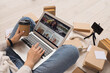 © Pixel-Shot - Female blogger using laptop with coffee cup and books on floor, closeup