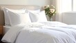 © moca - A neatly made bed with white linens and pillows