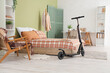 © Pixel-Shot - Interior of stylish bedroom with electric scooter and workplace