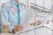 © Pixel-Shot - Young businessman reading newspaper in office, closeup