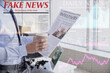 © Pixel-Shot - Young businessman with cup of coffee reading newspaper in office