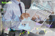 © Pixel-Shot - Young businessman reading newspaper in office