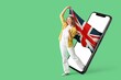 © Pixel-Shot - Going woman with flag of UK and big mobile phone with blank screen on green background