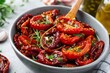 © Lubos Chlubny - Sun dried tomatoes marinating with olive oil and herbs