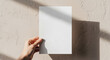 © Zaxenart - Blank Flyer Mockup Held by Hand in Soft Neutral Beige Room