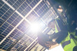 © ultramansk - Engineer in safety vest and helmet pointing towards a solar powered carport, illustrating eco-friendly innovation in parking infrastructure. Solar panels provide shade and sustainable energy.