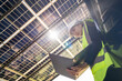 © ultramansk - Engineer in safety vest and helmet pointing towards a solar powered carport, illustrating eco-friendly innovation in parking infrastructure. Solar panels provide shade and sustainable energy.