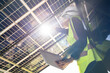 © ultramansk - Engineer in safety vest and helmet pointing towards a solar powered carport, illustrating eco-friendly innovation in parking infrastructure. Solar panels provide shade and sustainable energy.