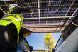 © ultramansk - Engineer in safety vest and helmet pointing towards a solar powered carport, illustrating eco-friendly innovation in parking infrastructure. Solar panels provide shade and sustainable energy.