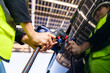© ultramansk - Engineer in safety vest and helmet pointing towards a solar powered carport, illustrating eco-friendly innovation in parking infrastructure. Solar panels provide shade and sustainable energy.