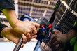 © ultramansk - Engineer in safety vest and helmet pointing towards a solar powered carport, illustrating eco-friendly innovation in parking infrastructure. Solar panels provide shade and sustainable energy.