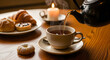 © MD - Tea being poured into a cup with saucer and plate of pastries