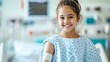 © Design@22 - Close-up portrait of a cheerful girl in a blue hospital gown, bandaged arm, smiling brightly. Portraying child's hope and resilience during medical recovery., Wellbeing, Child