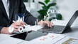 © Father_Studio - Businessman analyzing financial charts with business intelligence concept, banking analytics, market canvassing, data driven insights and corporate finance strategy.