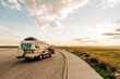 © Cavan Images - Retro Camper van parked along prairie road at sunset in South Da