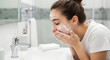 © Lexi - Teenage girl washing her face with cleanser in modern bathroom