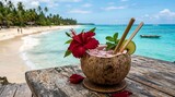 Koktail tropis menyegarkan yang disajikan dalam kelapa berlubang dengan bunga kembang sepatu, jeruk nipis, dan sedotan bambu di dekat pantai dan laut biru kehijauan. Summer vibes