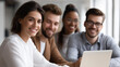© Kateryna Arkhypova - Group of people sitting around a table with a laptop in a collaborative work setting, teamwork and digital collaboration concept, defocused background, with copy space