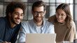© Kateryna Arkhypova - Happy young diverse business professionals working together on a laptop in a contemporary office setting, teamwork and digital collaboration concept, defocused background, with copy space