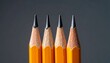 © Abdul - Macro shot of four sharpened yellow pencils in a row on a dark background