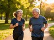 © Abdelati - Active senior couple jogging in park, happy elderly man and woman running together, healthy lifestyle for retired people in golden hour sunlight isolated on White Background