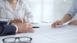 © volha_r - Business people discussing contract details during an important corporate meeting, partners reviewing legal documents with an attorney, collaborating on an agreement