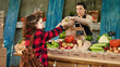 © DC Studio - Young woman client smelling apples and shopping at farmers market, female buyer standing near stand choosing locally grown fresh organic fruits and vegetables. Visiting food marketplace.