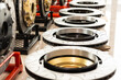 © JP.Studio - Close up brake disc rotors with drilled and slotted surface performance automotive parts displayed in workshop high quality metal components for vehicle braking system