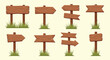 © Miken - Collection of rustic wooden signboards and directional pointers with patches of green grass growing at the base of the posts.