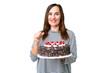 © luismolinero - Middle age caucasian woman holding birthday cake over isolated chroma key background proud and self-satisfied