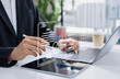 © Father_Studio - Businessman approving digital invoice on tablet and laptop, paperless billing system, e invoice management, and efficient online finance workflow.