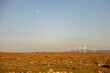 © ADDICTIVE STOCK - Wind turbines on arid plain under clear sky and moon