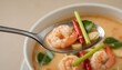 © Food stock - Delicious Tom Yum soup with a plump shrimp and aromatic herbs on a silver spoon