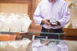 © .shock - Couple buying a wedding ring at a jewelry store while paying with a card machine