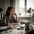 © SashaMagic - Focused woman working on laptop in modern home office