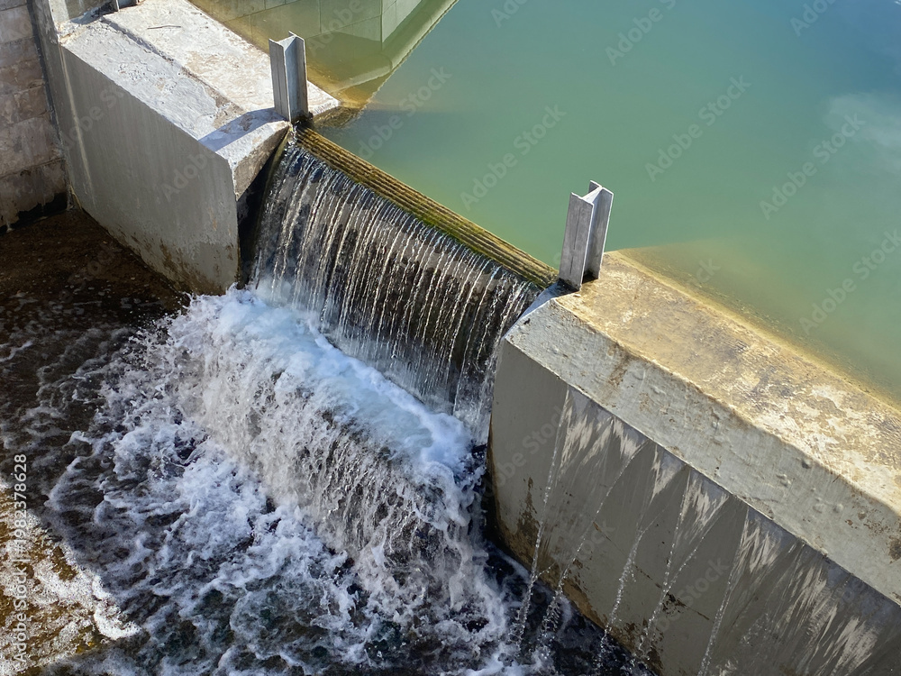Flashboard Riser Structures Flashboard Dam, overflow weir. Water flows under bridge through stepped ...