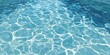 © afdal - A vibrant, overhead view showcases the shimmering surface of clear blue water, reflecting sunlight and creating a mesmerizing pattern of light and shadow.