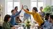 © Alula - Authentic office scene with diverse colleagues celebrating success with a high-five, fostering teamwork and collaboration in a positive environment