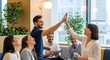© Alula - Joyful Business Team Celebrates Success with a High Five in a Modern Office Setting