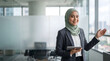 © Unimaginable Pic - Confident muslim businesswoman with tablet in glass office
