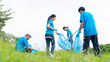 © BJ Day Stock - Volunteering, charity and clean environment concept. Happy asian diverse group of volunteers with garbage bags wearing blue t-shirt and cleaning area in park or roadside, copy space.