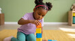 © OlgaNeuroArt - Young Black girl stacking colorful wooden blocks on a rug. Child playing and learning at home. Early childhood development and education concept