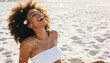 © Anna - Joyful Black woman with afro laughing on a sunny beach. Happy young female with water droplets on skin during summer vacation. Skincare and wellness concept on the coast