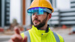 © Curioso.Photography - Construction worker wearing helmet and safety vest with protective glasses symbolizing industrial safety and engineering work.