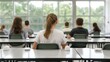 © Intelligent Horizons - A classroom scene with multiple young students from behind seated at desks under natural window light suggesting a test or focused learning session with modern technology present