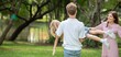 © BESTIMAGE - Smiling father holding daughter and spinning her playful outdoors joyful moment emotional happy family bonding. Cheerful Dad Holding Kid Up Having Fun Together in Green Park.