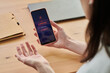 © pressmaster - Young adult woman holding smartphone showing no mobile network error while working at desk, expressing frustration. Ideal for telecom outage, connectivity problem, remote work disruption themes