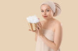 © Pixel-Shot - Pretty young woman with bath supplies on beige background