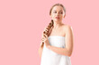 © Pixel-Shot - Pretty young woman wrapped in towel on pink background